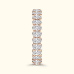 Rose gold ring featuring a row of sparkling round diamonds set in a prong setting.