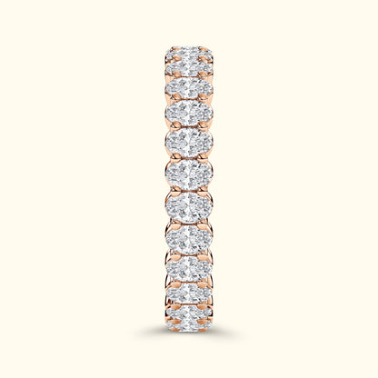 Rose gold ring featuring a row of sparkling round diamonds set in a prong setting.