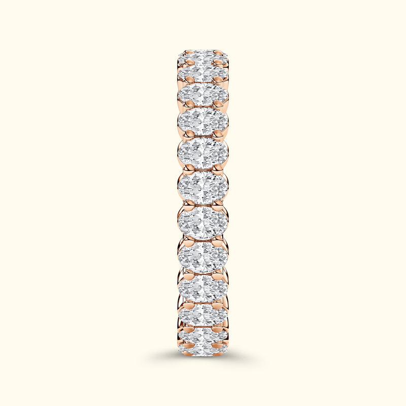 Rose gold ring featuring a row of sparkling round diamonds set in a prong setting.