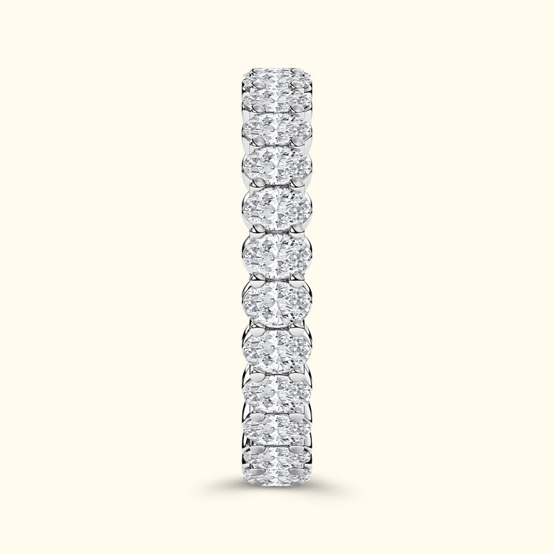 A vertical row of sparkling diamond rings set in a sleek silver band.