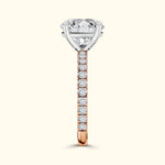 Elegant diamond engagement ring featuring a large center stone and a rose gold band decorated with smaller diamonds.