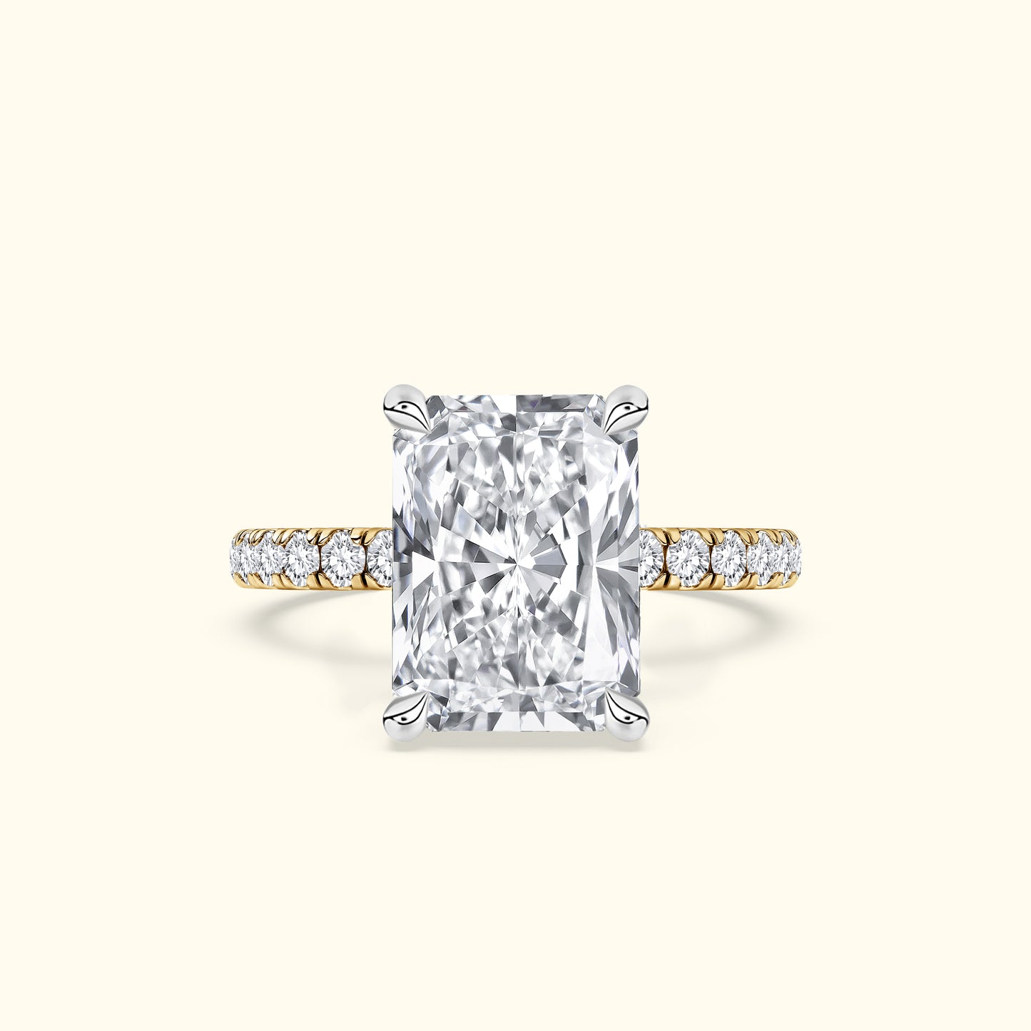 Rectangular diamond engagement ring with a gold band and smaller diamonds on the shank.