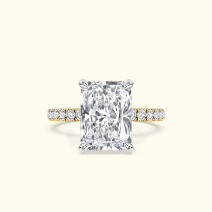 Rectangular diamond engagement ring with a gold band and smaller diamonds on the shank.