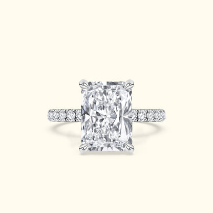 Brilliant emerald-cut diamond engagement ring with a pave band.