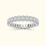 Silver band ring adorned with multiple sparkling round diamonds.
