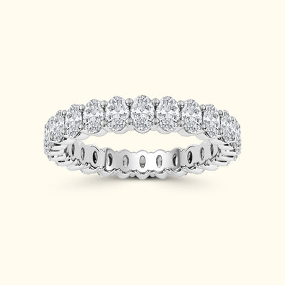 Silver band ring adorned with multiple sparkling round diamonds.