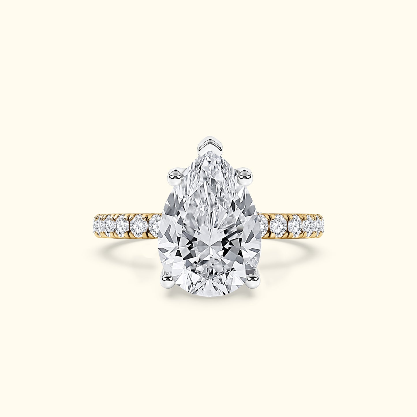 Stunning pear-shaped diamond ring with a gold band and smaller diamonds along the shank.