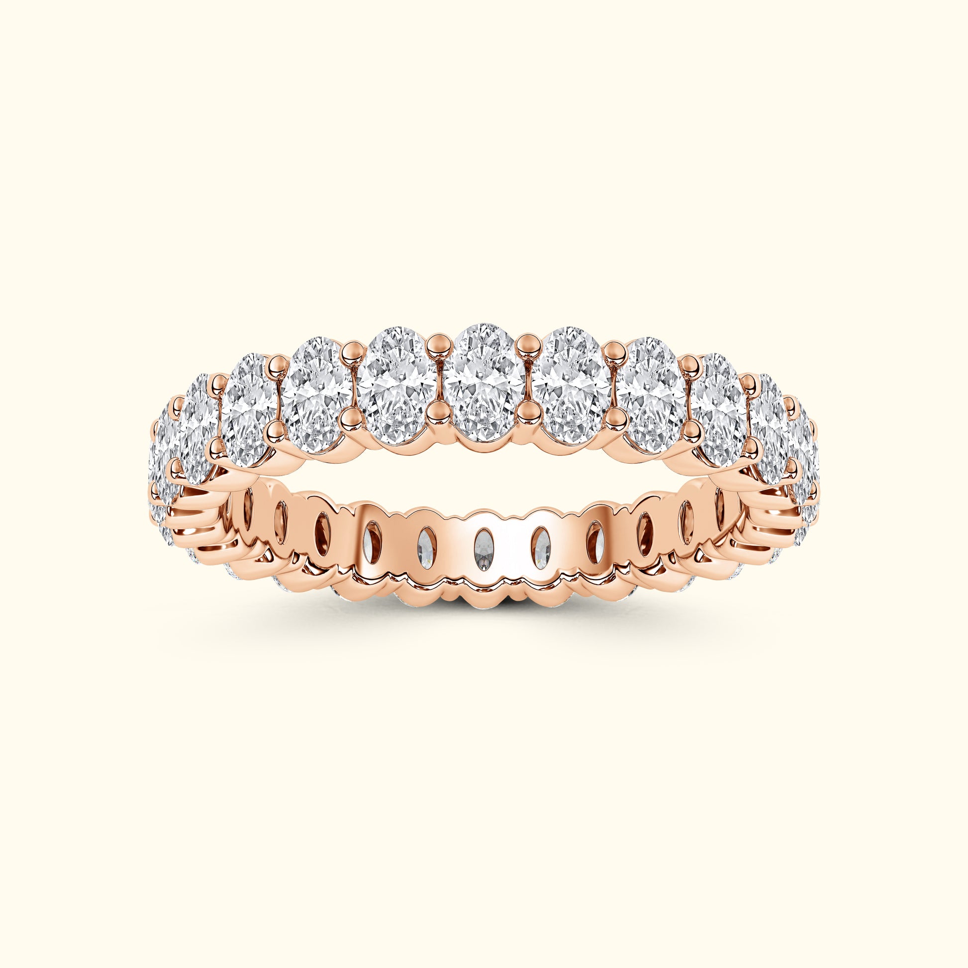 Rose gold ring featuring a row of oval diamonds set in a sparkling band.