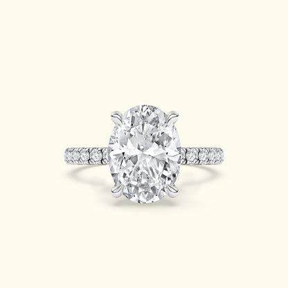 Oval diamond engagement ring with a sparkling band and accent stones.