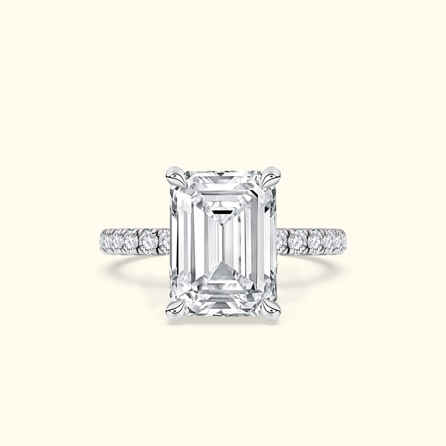 Elegant emerald-cut diamond ring with a delicate pavé band.