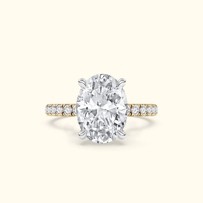 Elegant oval diamond ring with a gold band and sparkling side stones.