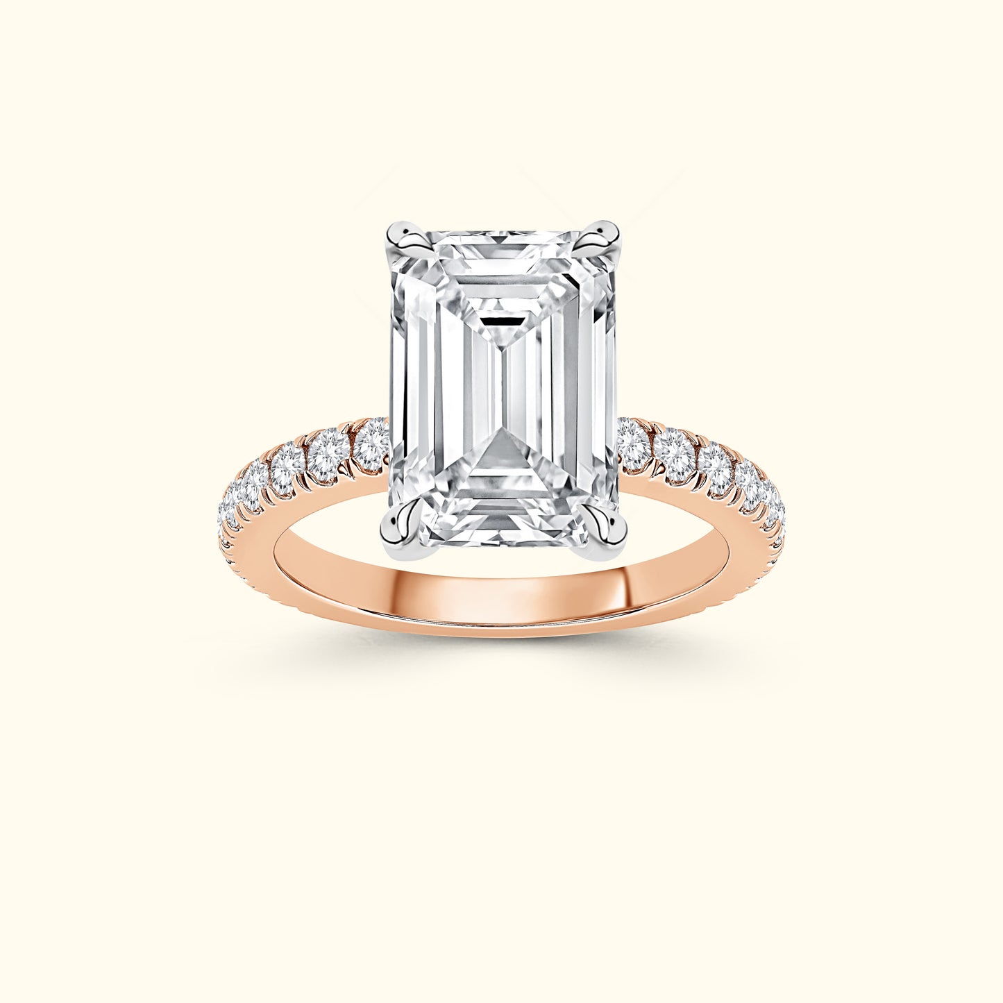 Emerald-cut diamond ring with a rose gold band and smaller diamonds on the band.