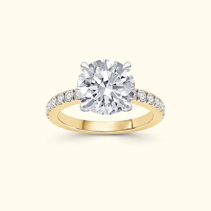 A sparkling diamond engagement ring with a round center stone and a yellow gold band.