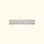 Rose gold ring featuring a line of oval diamonds.