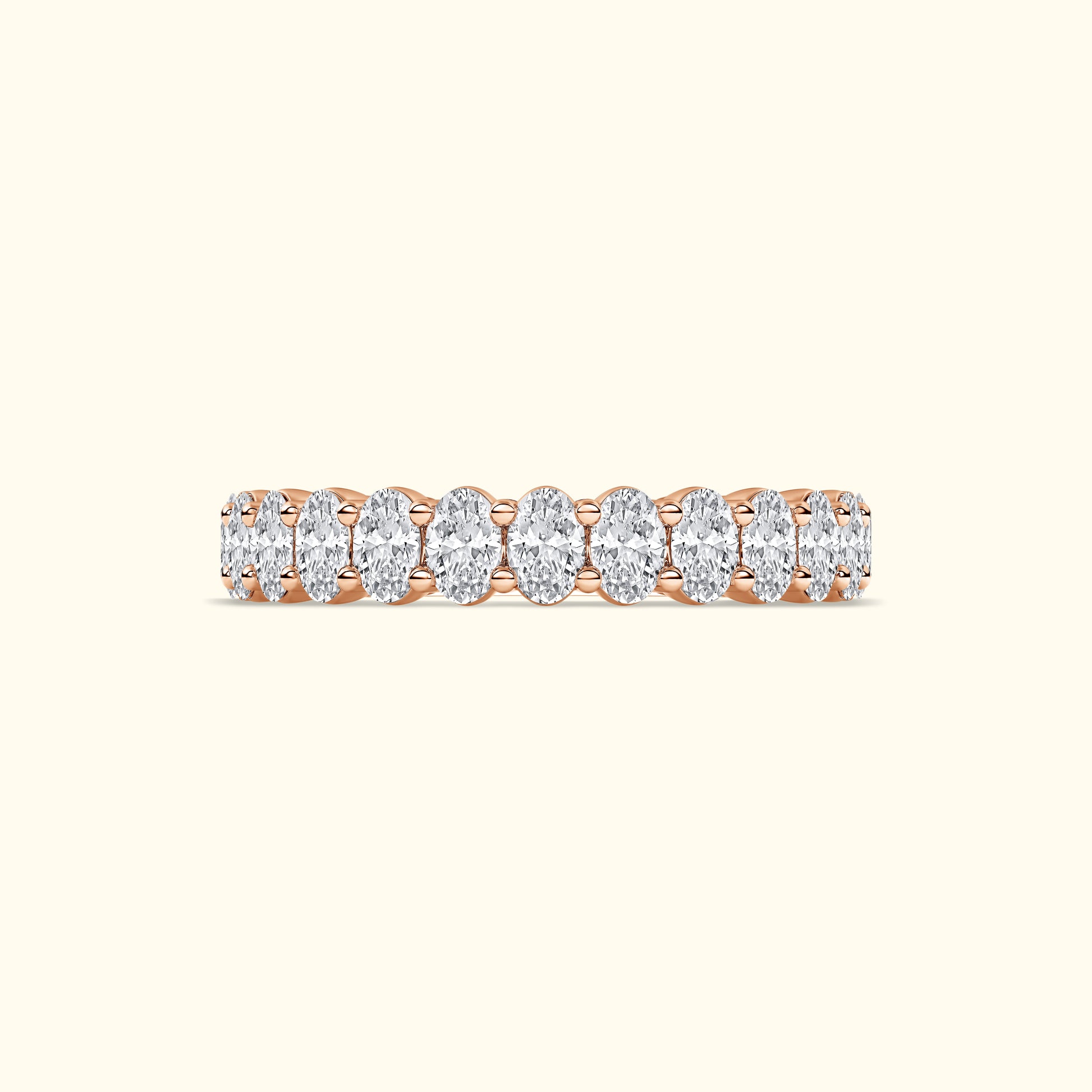 Rose gold ring featuring a line of oval diamonds.