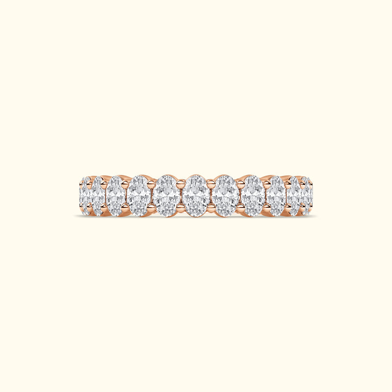 Rose gold ring featuring a line of oval diamonds.