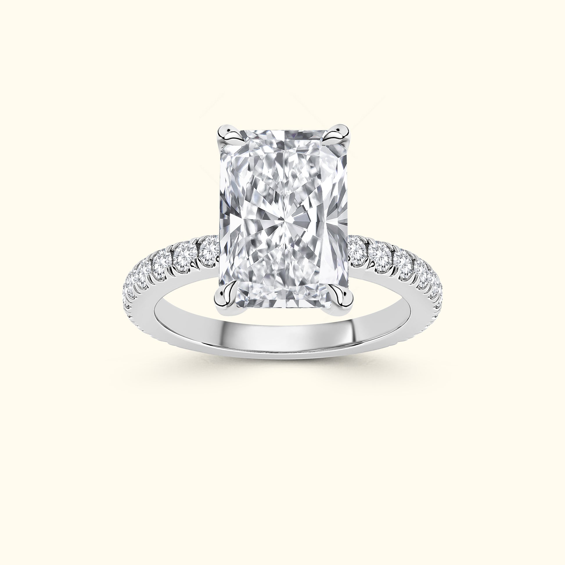 Elegant rectangular diamond ring with sparkling side stones on a silver band.