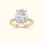 Oval diamond ring with a yellow gold band and smaller accent diamonds.