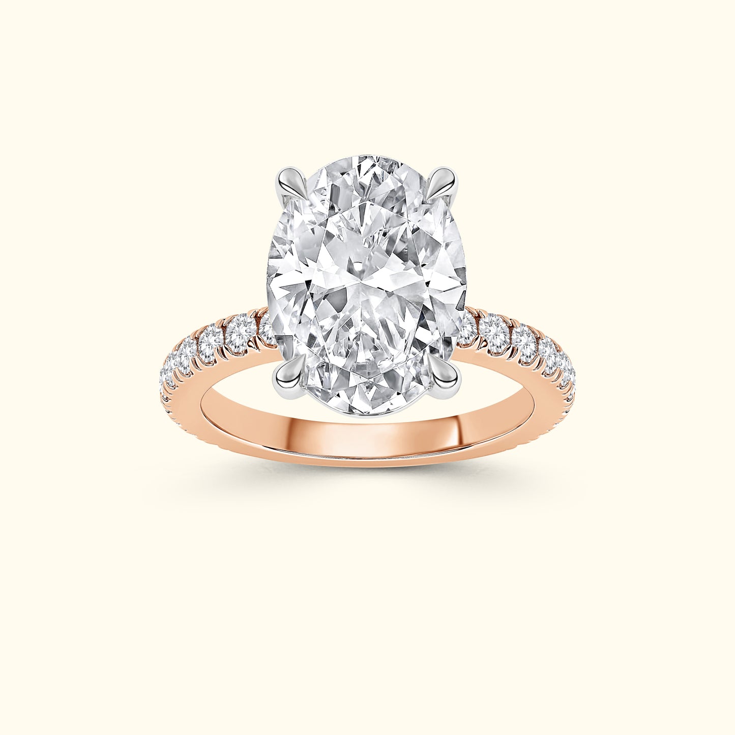 Oval diamond engagement ring with a rose gold band and smaller diamonds along the shoulders.