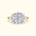 Three-stone diamond ring with a large center stone set in yellow gold.