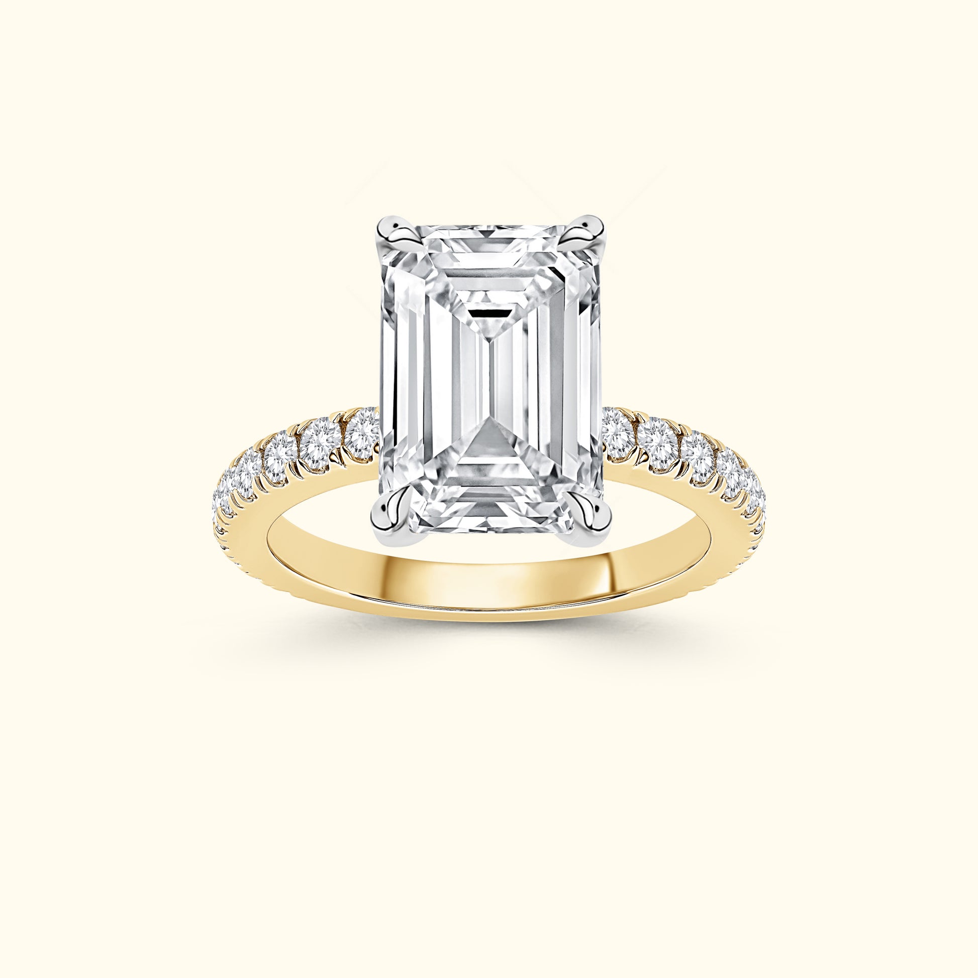 Emerald-cut diamond ring with a yellow gold band and smaller diamonds along the band.