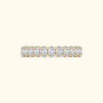 Golden band ring adorned with oval diamonds arranged in a row.