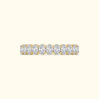 Golden band ring adorned with oval diamonds arranged in a row.