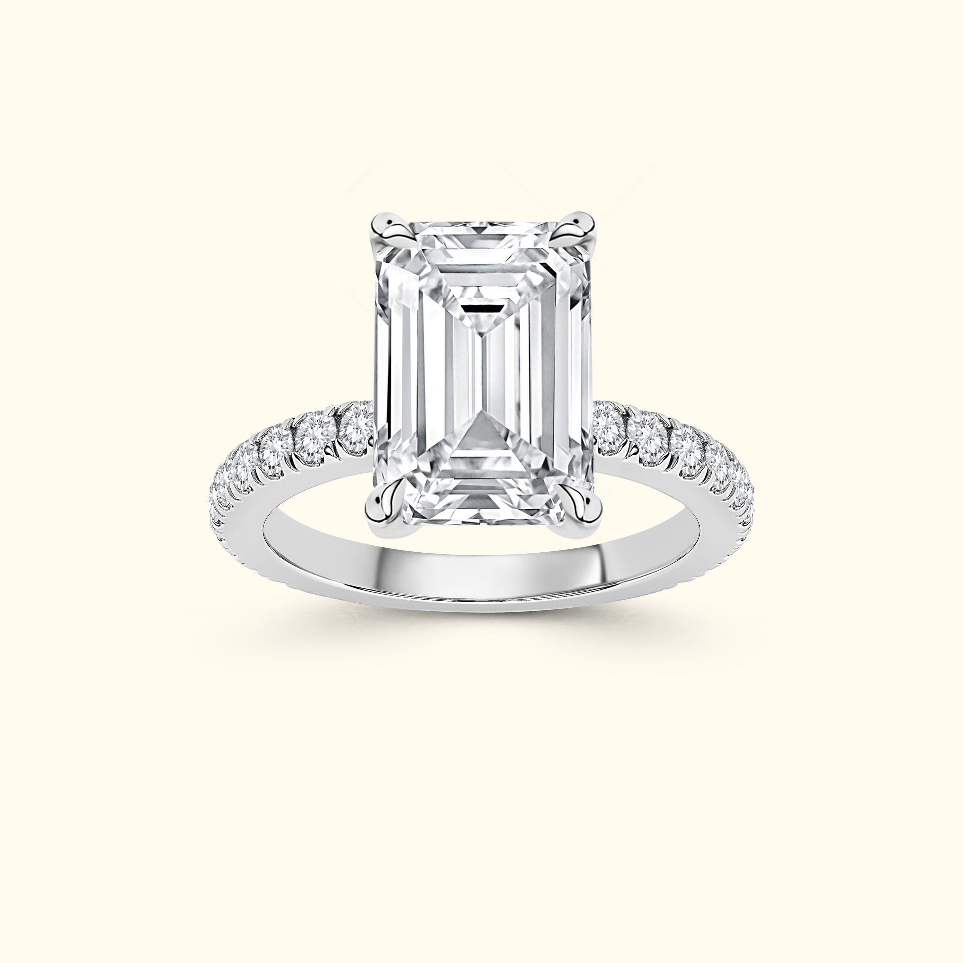 Brilliant emerald-cut diamond ring with a sparkling band of smaller diamonds.