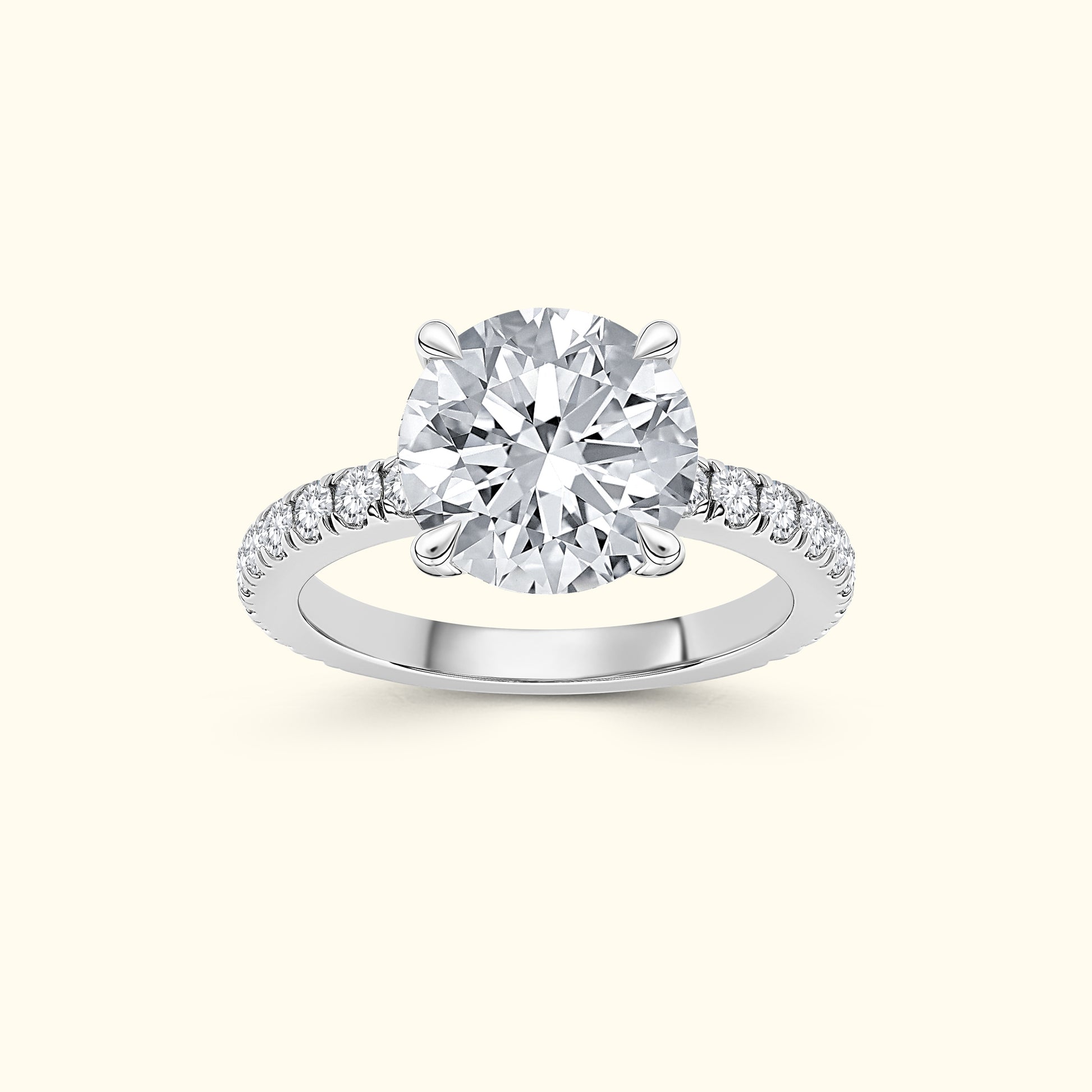 A solitaire diamond ring with a round center stone and smaller diamonds on the band.