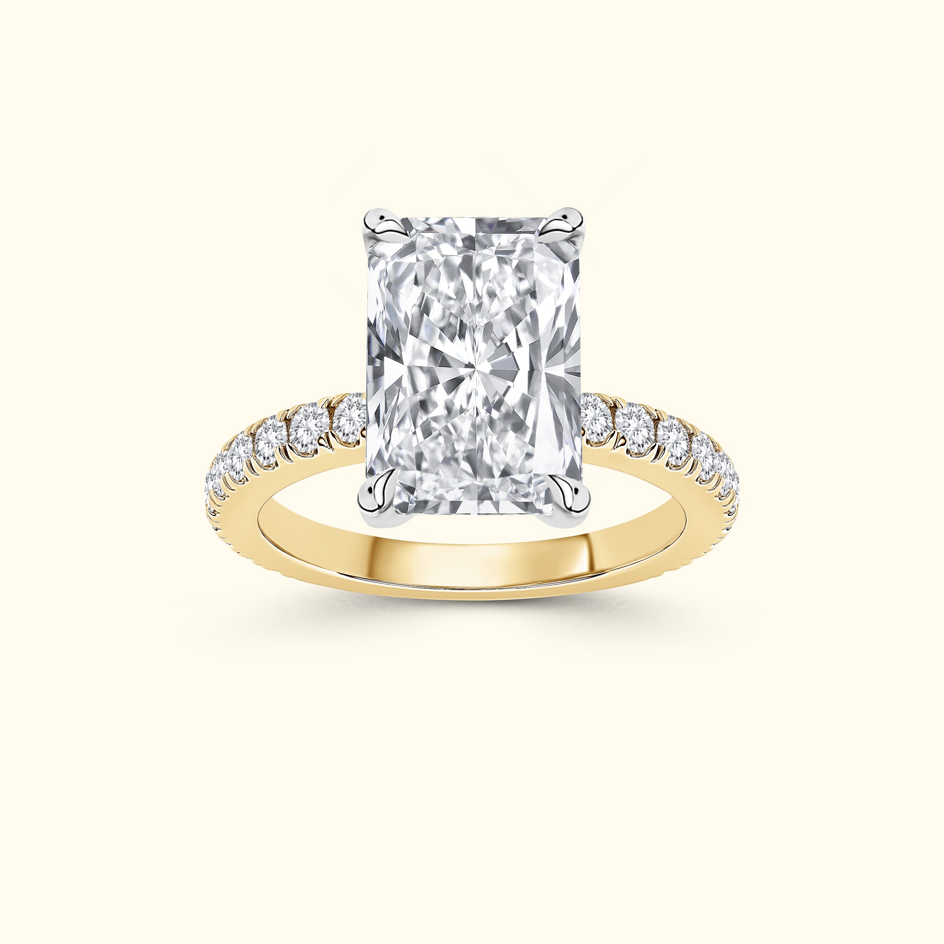 Rectangular diamond ring with a yellow gold band and small diamond accents.