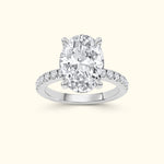 Sparkling oval-cut diamond ring with delicate side stones on a white gold band.