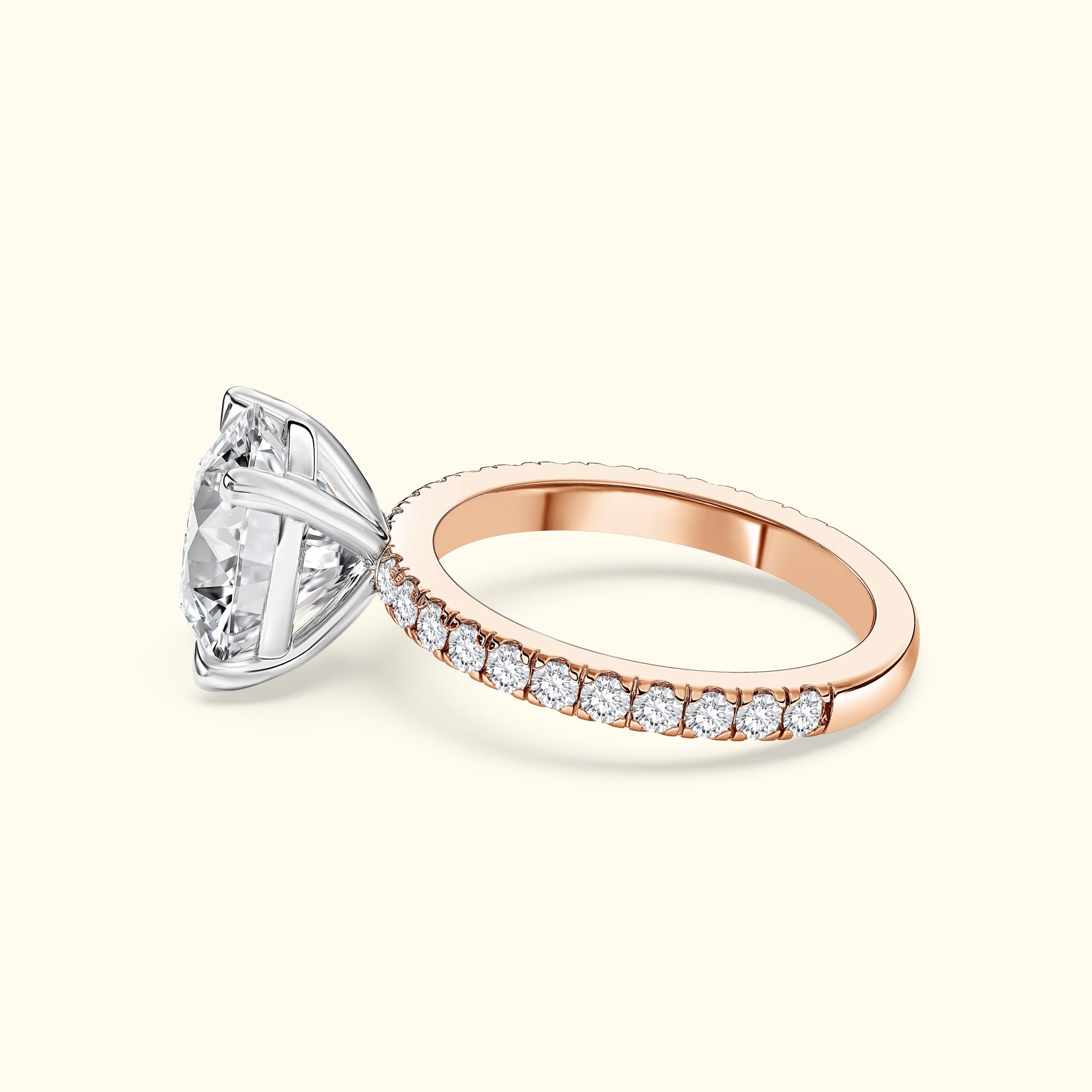 Rose gold engagement ring featuring a large, sparkling diamond and smaller surrounding stones.