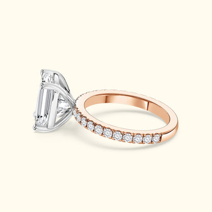 Elegant two-tone engagement ring with a large rectangular diamond and smaller accents.