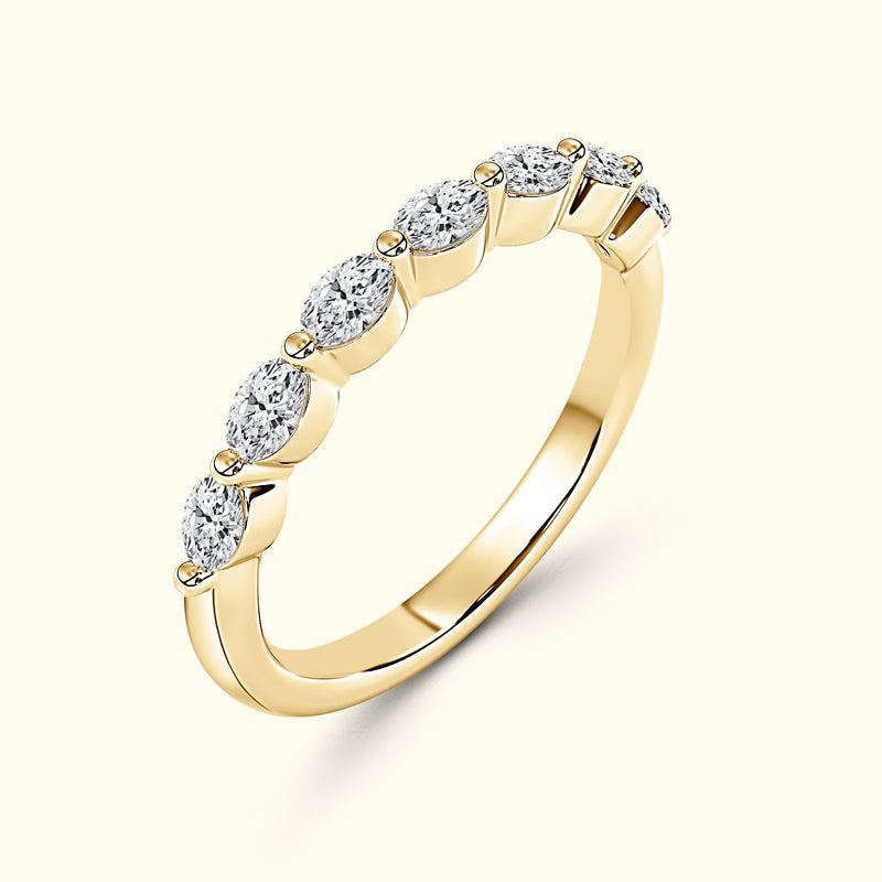 Elegant gold ring featuring six oval diamonds set in a row.