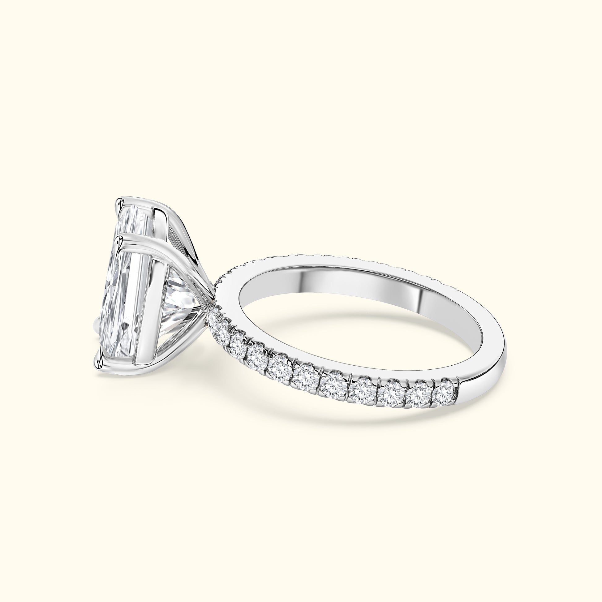 Elegant silver ring featuring a large rectangular diamond and a pave band of smaller diamonds.