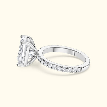 Elegant silver ring featuring a large rectangular diamond and a pave band of smaller diamonds.