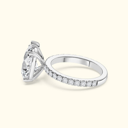 Elegant silver engagement ring with a large diamond and smaller stones along the band.