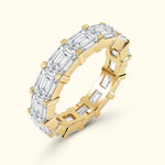 Elegant diamond band ring featuring alternating rectangular and round stones in gold and silver.
