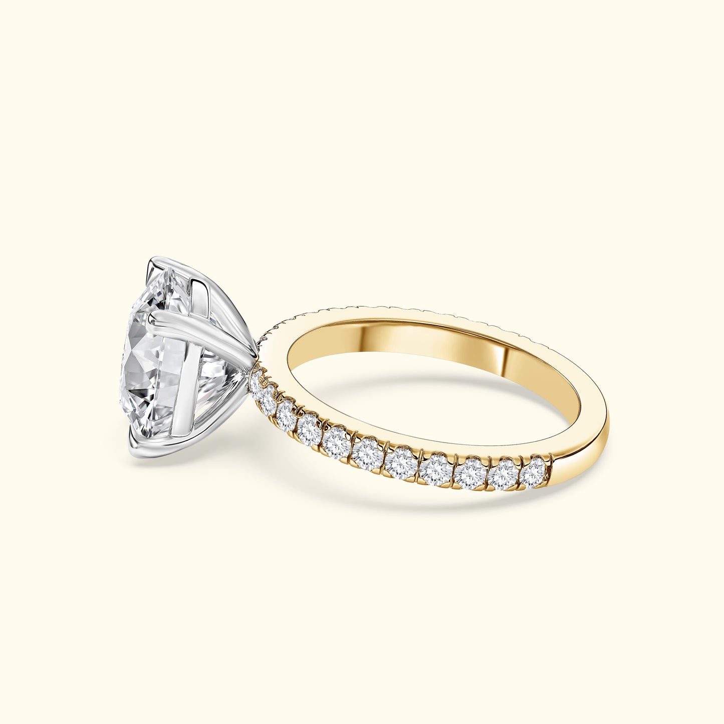 Gold and silver engagement ring featuring a large central diamond and smaller pavé diamonds.