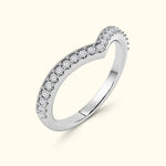 Elegant silver ring with a wavy band set with small sparkling diamonds.