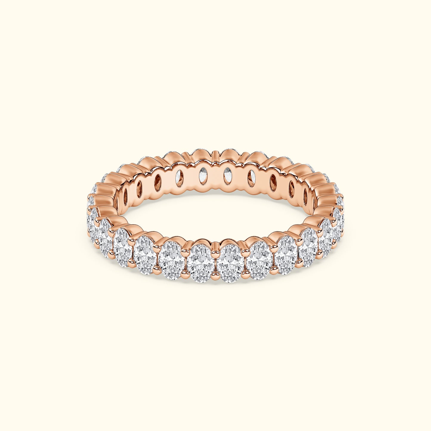 Rose gold ring adorned with sparkling oval diamonds, showcasing a scalloped design.