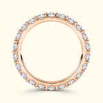 Rose gold ring adorned with sparkling pear-shaped diamonds around the band.