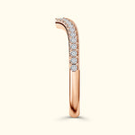 Rose gold ring with a curved design and a row of sparkling diamonds along the top.