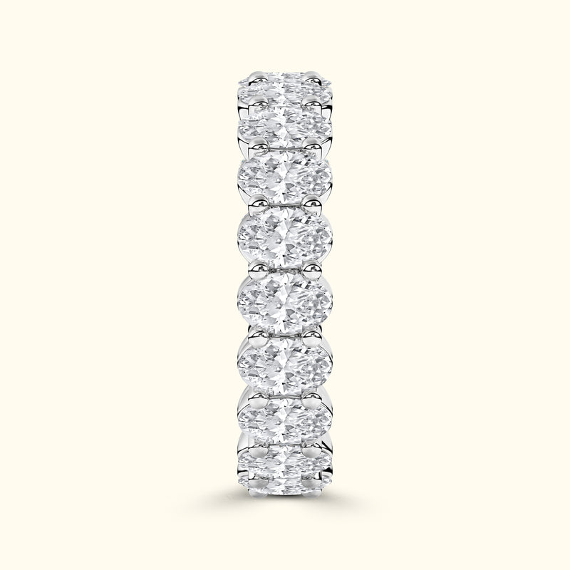 Elegant diamond band with alternating round and oval diamonds set in a smooth prong setting.
