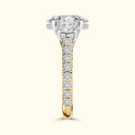 Elegant two-tone engagement ring featuring a large diamond and smaller side stones.