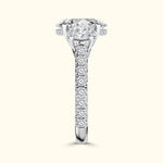 Solitaire engagement ring with a large diamond and pave-set side stones in a glossy band.