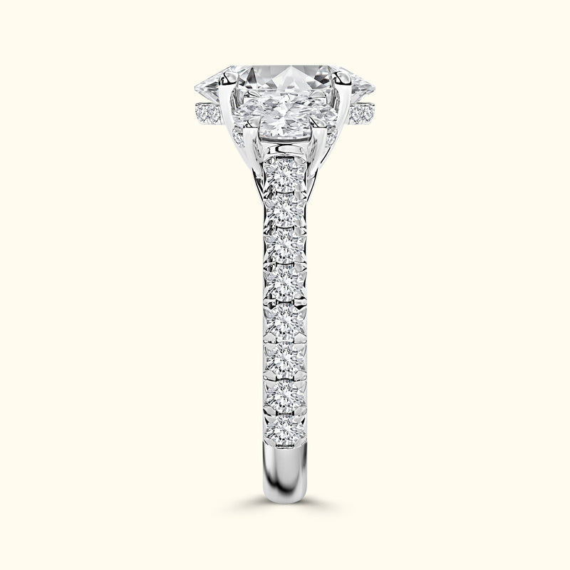 Solitaire engagement ring with a large diamond and pave-set side stones in a glossy band.