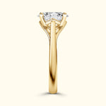 Solitaire engagement ring with a large diamond, set in a polished yellow gold band.