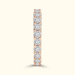Rose gold band adorned with sparkling round diamonds.