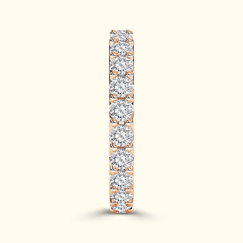 Rose gold band adorned with sparkling round diamonds.